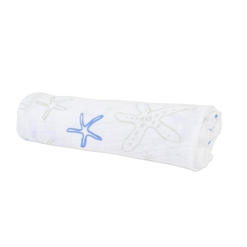 Large 47x47 inch muslin swaddle blanket with starfish pattern draped in nursery