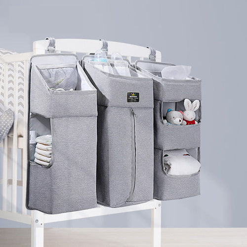Baby diaper caddy organizer with dividers filled with diapers, wipes and essentials